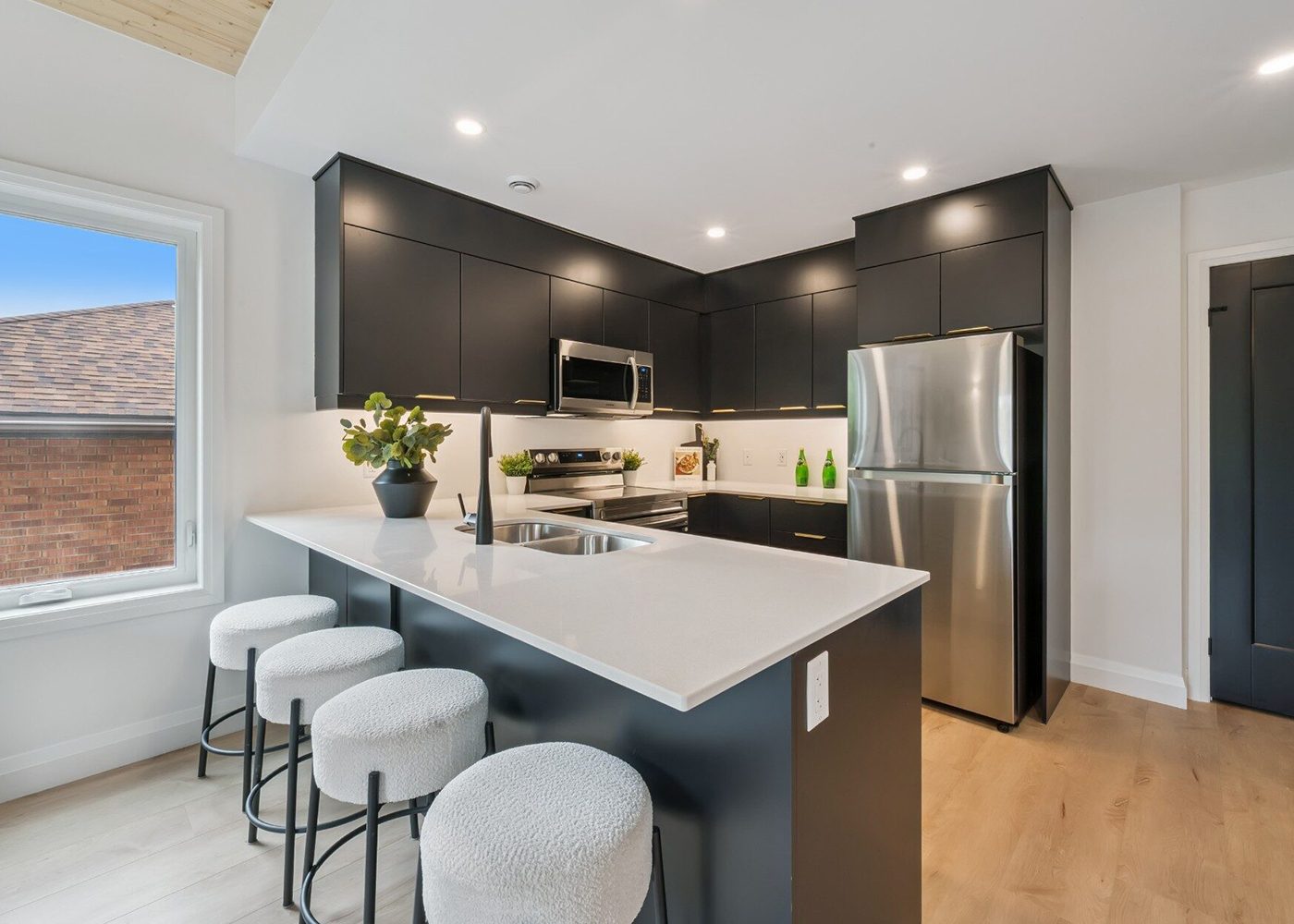 Suite kitchen with island seating and large window