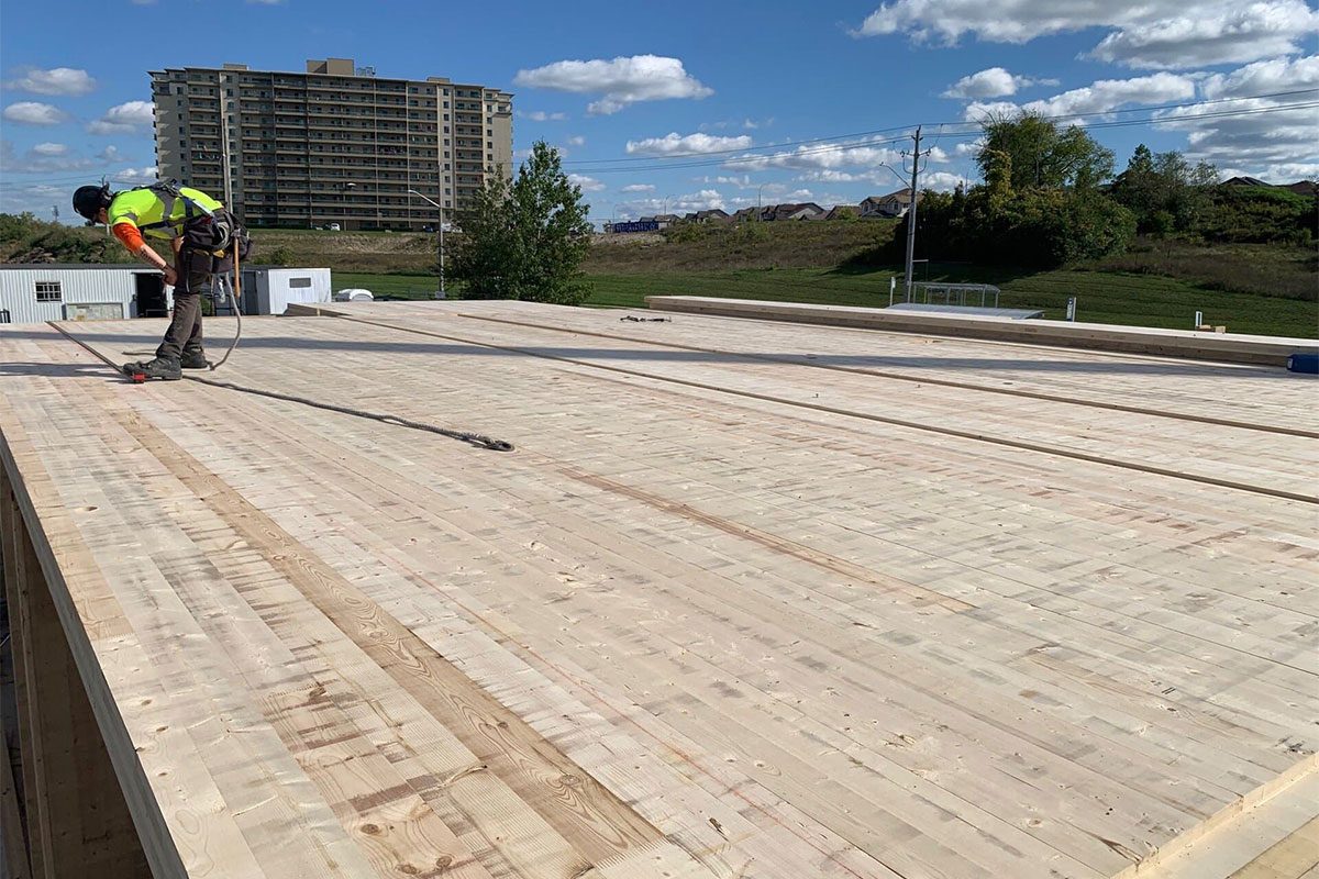 Worker on an installed cross-laminated timber floor deck
