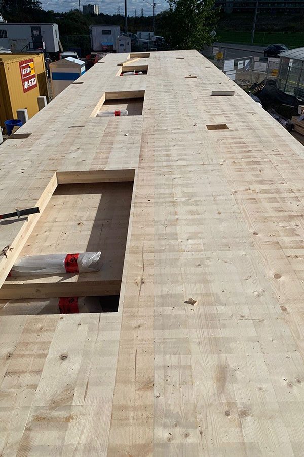 Close view of a timber floor panel with service openings