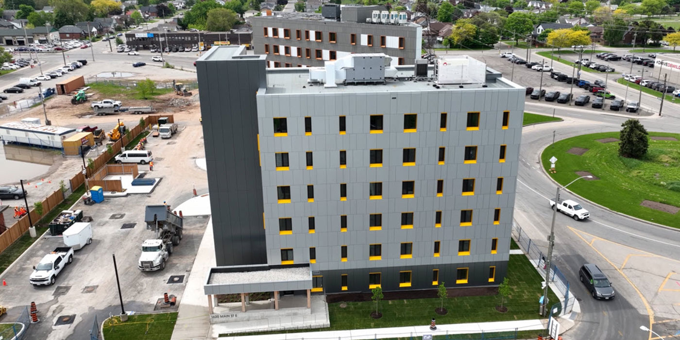 Aerial view near completion with grey cladding and yellow window reveals